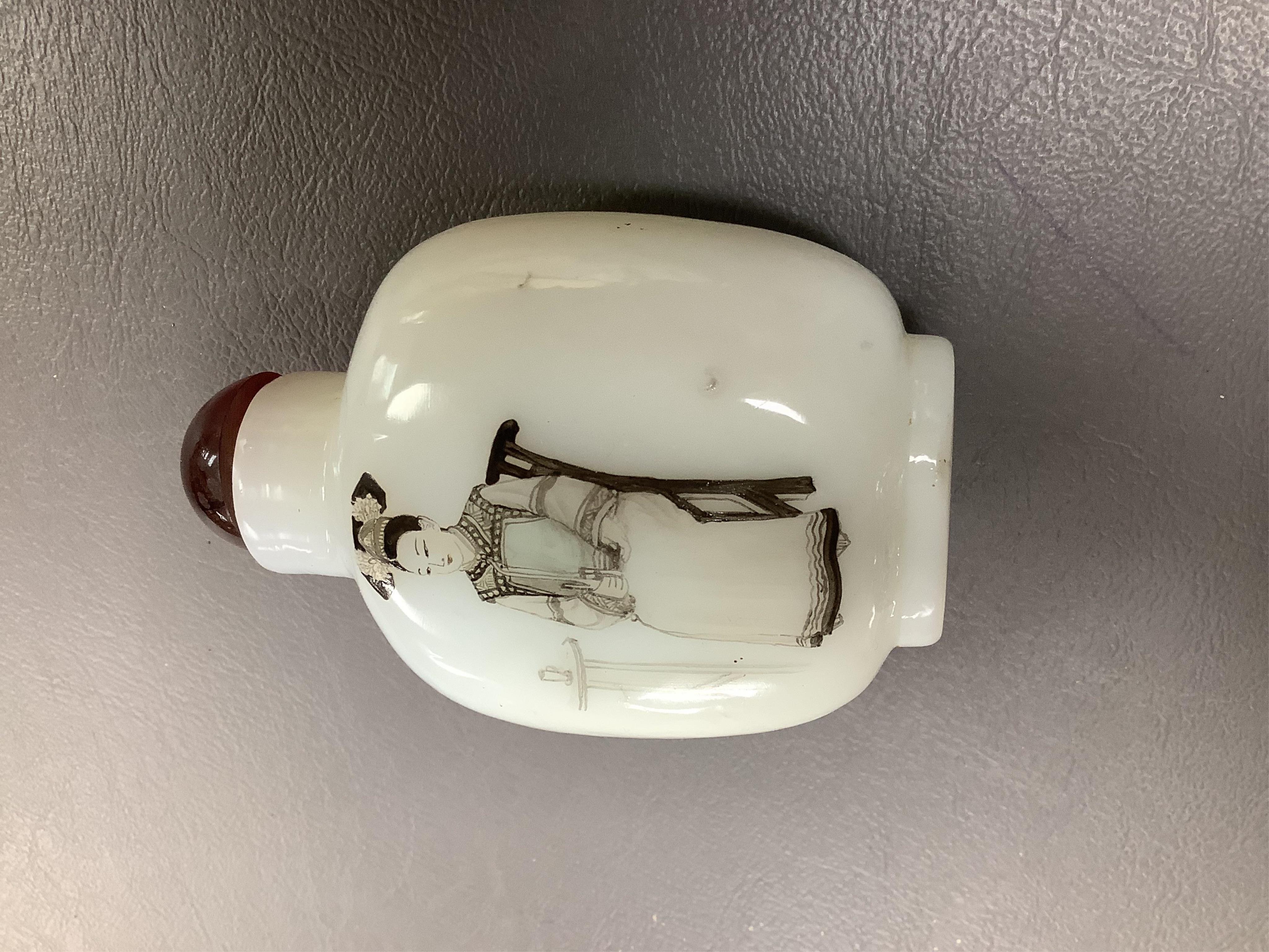 A Chinese enamelled white glass snuff bottle, a blue and white bird feeder and a famille rose vase, the first 9cm